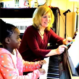 Young beginner student at the piano at DenLee Music School